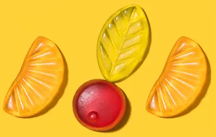 top view of tasty gummy fruits on yellow surface